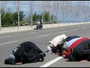 Bowing to Allah. They do this three times a day, where ever they are.